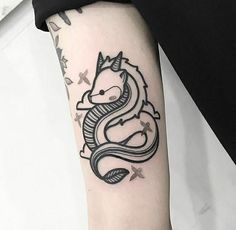 a black and white photo of a dragon tattoo on the left arm, with stars in the background