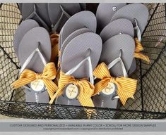 several pairs of gray flip flops with yellow bows are sitting in a mesh basket