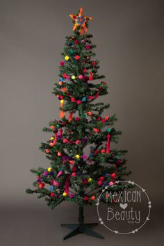 a small christmas tree decorated with multicolored ornaments