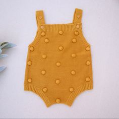 This Adorable Pom Pom Romper Bodysuit Is Sleeveless And Has Adjustable Straps With Two Lengths. There Is Ribbed Trim Along The Neckline And Legs. Available In White And Marigold. Sleeveless Yellow Cotton Bubble Romper, Cute Yellow Sleeveless Bubble Romper, Cute Sleeveless Yellow Bubble Romper, Yellow Casual Bubble Romper For Playtime, Casual Yellow Bubble Romper For Playtime, Playful Yellow Bubble Romper For Playwear, Casual Yellow Bubble Romper For Playwear, Cute Yellow Bubble Romper For Playwear, Modern Boho Minimalist