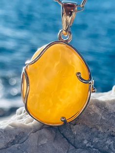 Pendant material and details : * White landscape Amber and Gold-plated Sterling Silver  * Stone : Natural Baltic Amber * Silver hallmark :Ag 925 * Pendant length : 5,5 cm * Pendant width: 3,5cm * Pendant weight: 13,0  g *Color :  White , Yellow Luxury Amber Necklace With Polished Finish, Gold Baltic Amber Necklace For Gift, Oval Baltic Amber Necklace, Elegant Baltic Amber Jewelry With Natural Stones, Gold Pendant Necklace With Baltic Amber, Gold Baltic Amber Jewelry With Polished Finish, Polished Amber Citrine Necklace, Handmade Yellow Baltic Amber Necklaces, Baltic Amber Jewelry With Natural Stones For Gifts