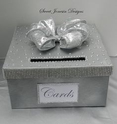 a silver box with a bow on it