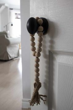 the door handle is made out of wood beads and tasseled with black balloons