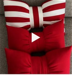 red and white pillows on a couch with an arrow pointing to the pillow in the middle