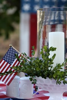 an american flag table setting with candles and greenery