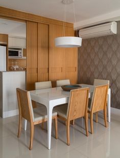 a dining room table with four chairs around it