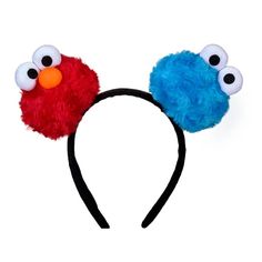 a red and blue headband with two googly eyes on top of each ear