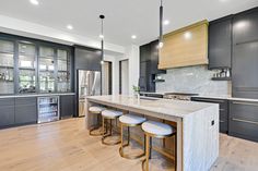 a kitchen with wooden floors and gray cabinets