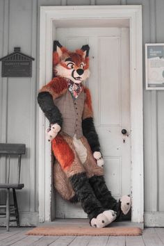 a stuffed fox is sitting in the doorway