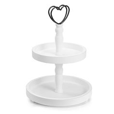 two tiered cake stand with a heart on it's top and the base is made out of white plastic