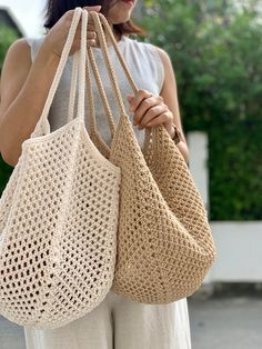 a woman holding two bags in her hands