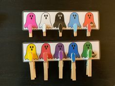 four popsicles with different colored ghost faces on them