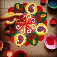 someone is making a colorful rangdil on the floor