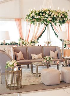 a living room filled with lots of furniture and flowers