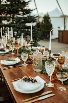 the table is set with candles and plates