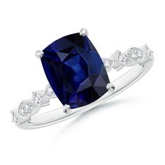 a blue sapphire and diamond ring with white diamonds on the band, set in 18k white gold