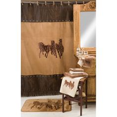 a brown shower curtain with horses on it and a mirror in the corner next to it