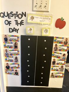 two black doors with magnets on them in front of a bulletin board that says question of the day