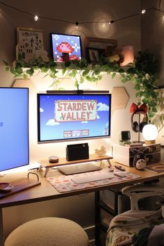 two computer monitors sitting on top of a wooden desk