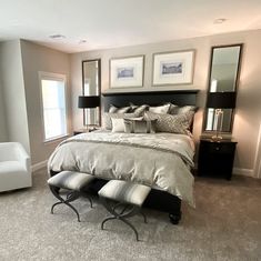 a bedroom with a large bed and two chairs