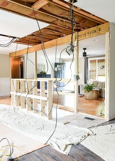 the inside of a house being built with wood and electrical wires hanging from the ceiling