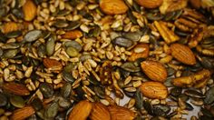 nuts and pumpkin seeds are mixed together in a mixture to make a nutritious snack