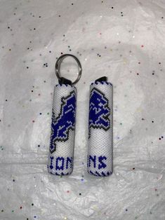 two keychains with the word lions on them