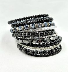 This large cuff bracelet is made on 14 rows of memory wire for the illusion of multiple stacked bracelets. It is filled with black and silver glass beads, crystals, bugle and seed beads, silver bead caps, Hematite, metal spacer beads, and topped off with 2 handmade drops at one end.  ★ Return to my main shop page here for more inventory ★ www.etsy.com/shop/bridgetollbeading ★ Read my FAQ's below and if you have any further questions please do not hesitate to contact me! ★ https://www.etsy.com/shop/BridgeTollBeading?ref=hdr#more-section Adjustable Stacked Black Beaded Bracelets, Adjustable Black Stretch Bracelet Hand Wrapped, Black Adjustable Hand Wrapped Crystal Bracelet, Adjustable Black Stackable Wrap Bracelet, Adjustable Stackable Black Wrap Bracelet, Black Adjustable Stackable Wrap Bracelet, Black Cuff Bracelet, Large Cuff Bracelet, Stacked Bracelets