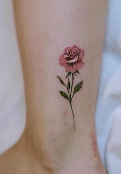 a small pink rose tattoo on the ankle