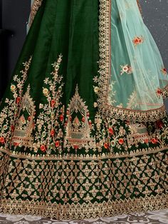 Look gorgeous in this stunning bottle green embroidered silk bridal lehenga choli from Ethnic Plus. This exquisite lehenga set is perfect for women who want to make a statement at their upcoming weddings and special occasions.
The lehenga is made of high-quality taffeta silk material in a beautiful bottle green color. It features intricate zari work, dori work, sequin work, diamond work, and embroidery work, adding a touch of elegance and sophistication. The attention to detail on this lehenga i Silk Bridal Lehenga, Dori Work, Zari Embroidery, Bridal Lehenga Choli, Bottle Green, Silk Material, Stone Work, Satin Silk, Bridal Lehenga