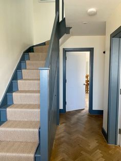 an empty hallway with stairs leading up to the door