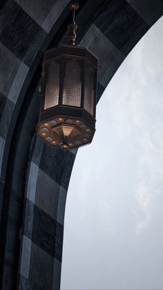 a light hanging from the side of a tall building