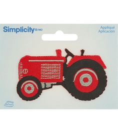 an applique patch with a red tractor on it's front and side