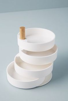 a stack of white plates with a wooden stick sticking out of the top and bottom