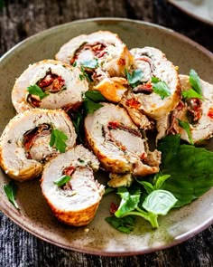 a plate filled with meat and vegetables on top of a wooden table