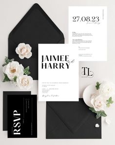 an elegant black and white wedding suite with flowers on the front, two envelopes and one