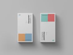 two boxes with different colors on them sitting side by side in front of a gray background