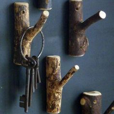 several pieces of wood are arranged on the wall with keys attached to them, including one key holder