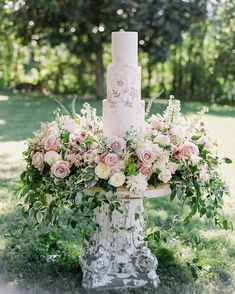 a white wedding cake with pink flowers and greenery on the top is displayed in an instagram