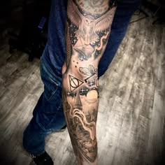 a man's leg with tattoos on it and an owl in the sky above him