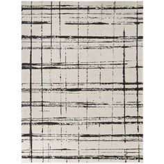 an abstract rug with black and white lines on the ground, in front of a white background