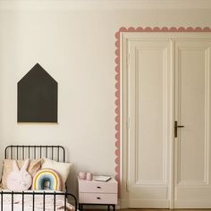 a bedroom with a bed, dresser and painting on the wall in pinks and whites