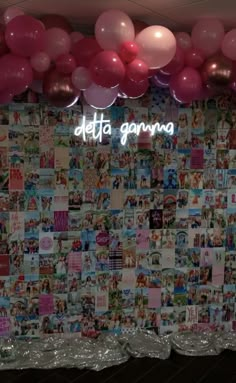 there is a wall covered with pictures and balloons in the room that says delta garna