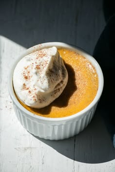 a white bowl filled with food on top of a table