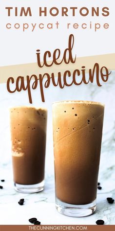 two glasses filled with iced cappuccino on top of a white countertop