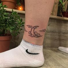 a person with a tattoo on their ankle