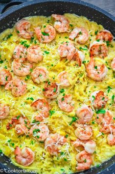 shrimp and rice casserole in a skillet with parmesan cheese sprinkled on top