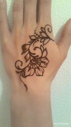 a woman's hand with a tattoo on it