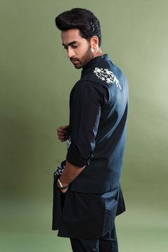 Black silk bundi with white bird, nature pattern embroidery, mandarin collar and patch pockets.
Component: 1
Pattern: Embroidered
Type Of Work: Bird and Nature
Neckline: Mandarin Collar
Sleeve Type: Sleeveless
Fabric: 100% Silk
Color: Black
Other Details: 
Front button closure
Note: The shirt, pants and kurta worn by the model is not for sale
Occasion: Sangeet,Destination Wedding - Aza Fashions Traditional Black Cotton Nehru Jacket, Nature Pattern, Embroidered Bird, Nehru Jackets, Pattern Embroidery, White Bird, Patterns In Nature, Embroidered Silk, Mandarin Collar