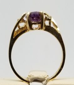 "We do not check prongs for wear or stones for looseness. All items are sold as is-noting that we are a resale shop so everything here had a previous owner! We will include flaws in the description when noted. This is one of the reasons our items are more affordable than new at a jewelry store. Vintage 10K Yellow Gold Ring with Amethyst & Diamonds, Size 5.75. Stamped 10KP inside band. Weighs 1.5 dwt. Please stop in often as we will be adding additional vintage fine jewelry beauties. Note tha Gold Amethyst Ring Collectible Fine Jewelry, Gold Amethyst Ring Fine Jewelry Collectible, Gold Amethyst Ring, Fine Jewelry Collectible, Gold Amethyst Ring In Fine Jewelry Style, Gold Amethyst Ring For Collectors, Oval Amethyst Ring Stamped 14k, Collectible Yellow Gold Amethyst Ring, Collectible Yellow Gold Amethyst Ring Stamped 14k, Yellow Gold Amethyst Ring Stamped 14k